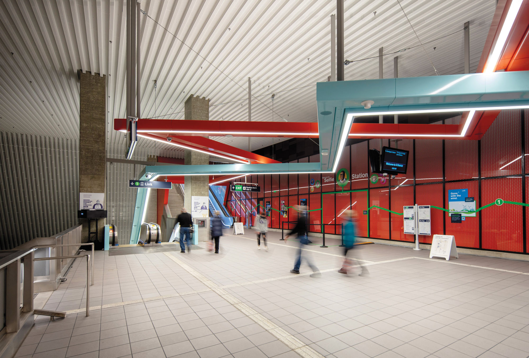 interior of train station with overhead zigzag lighting that acts as a wayfinding aid